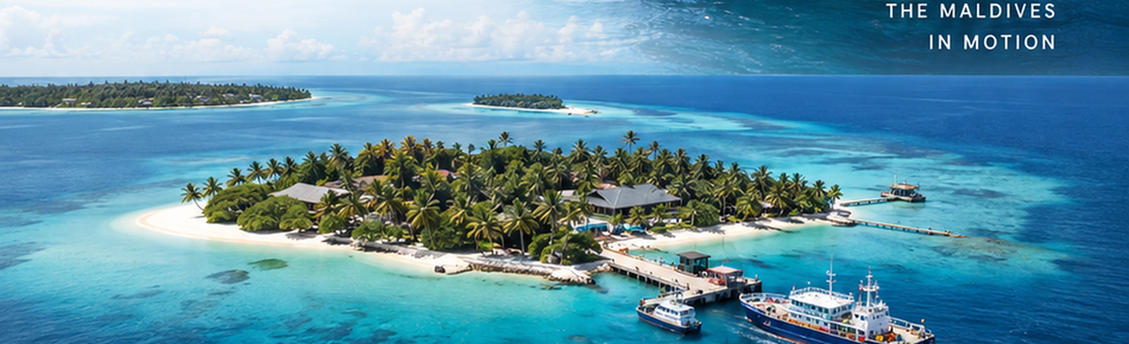 Aerial view of an inhabited Maldives island community with supply boats